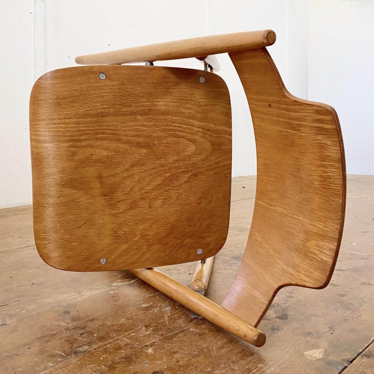 Deuxieme.shop Zwei Klappstühle, Modell SE18 von Egon Eiermann. Hergestellt von Wilde & Spieth. Sitz und Rücken Buche Sperrholz, ergonomisch formverleimt. Das zusammenklappbare Stuhlgestell ist aus Buche Vollholz. Die Stühle sind in stabilem Zustand mit warmer Alterspatina. 